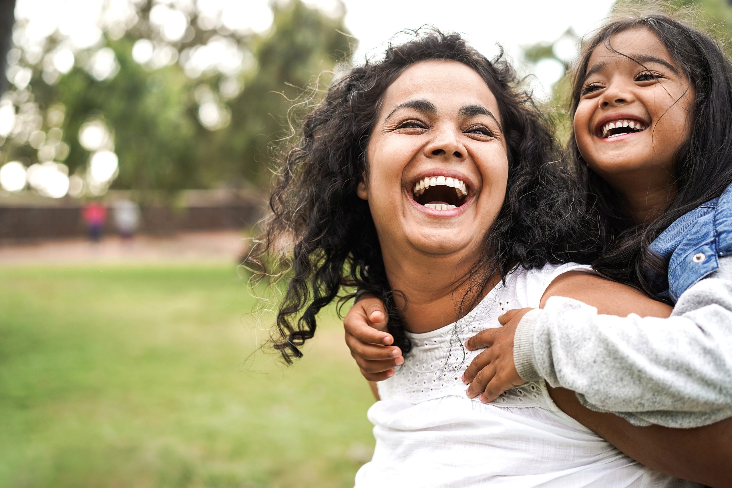 Happy mother having fun with her daughter outdoor - Family and love concept - Focus on mum face